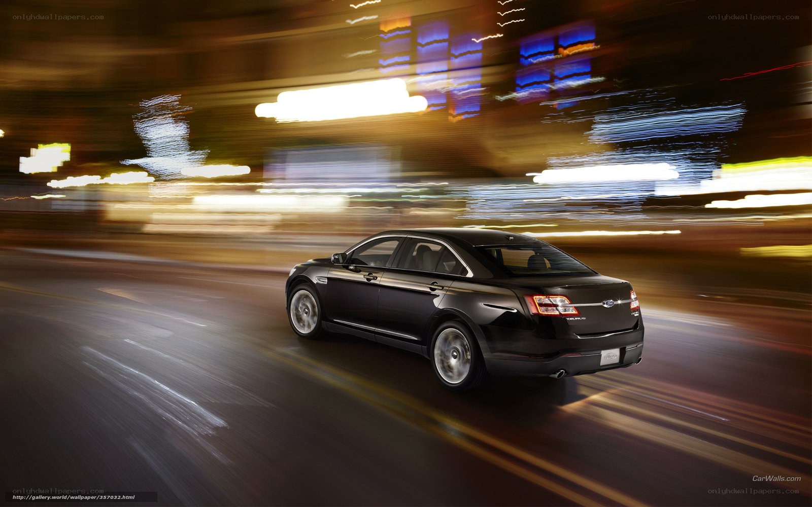 Black sedan driving at night