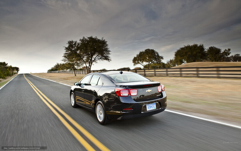 Black sedan driving on country road
