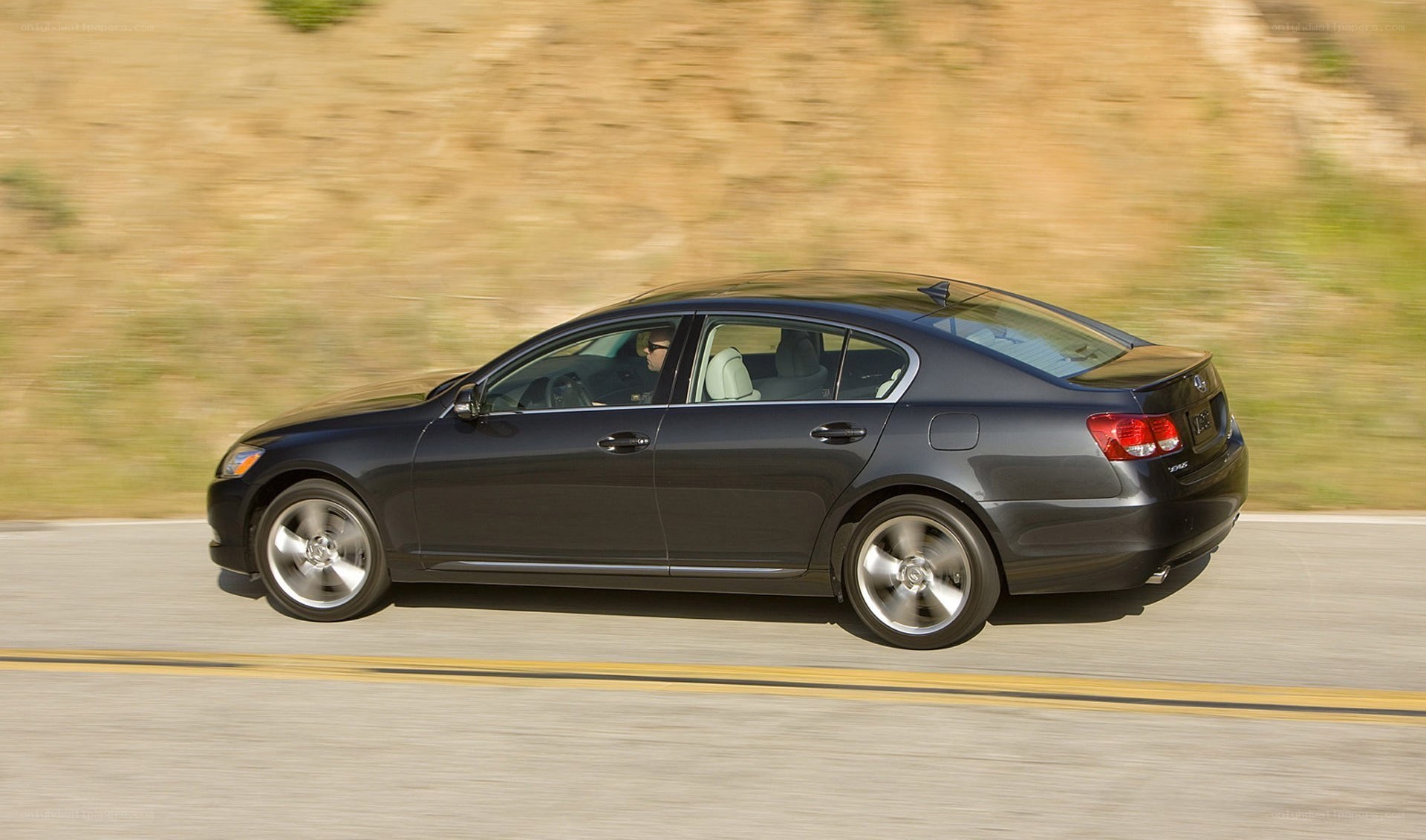 black sedan driving on road