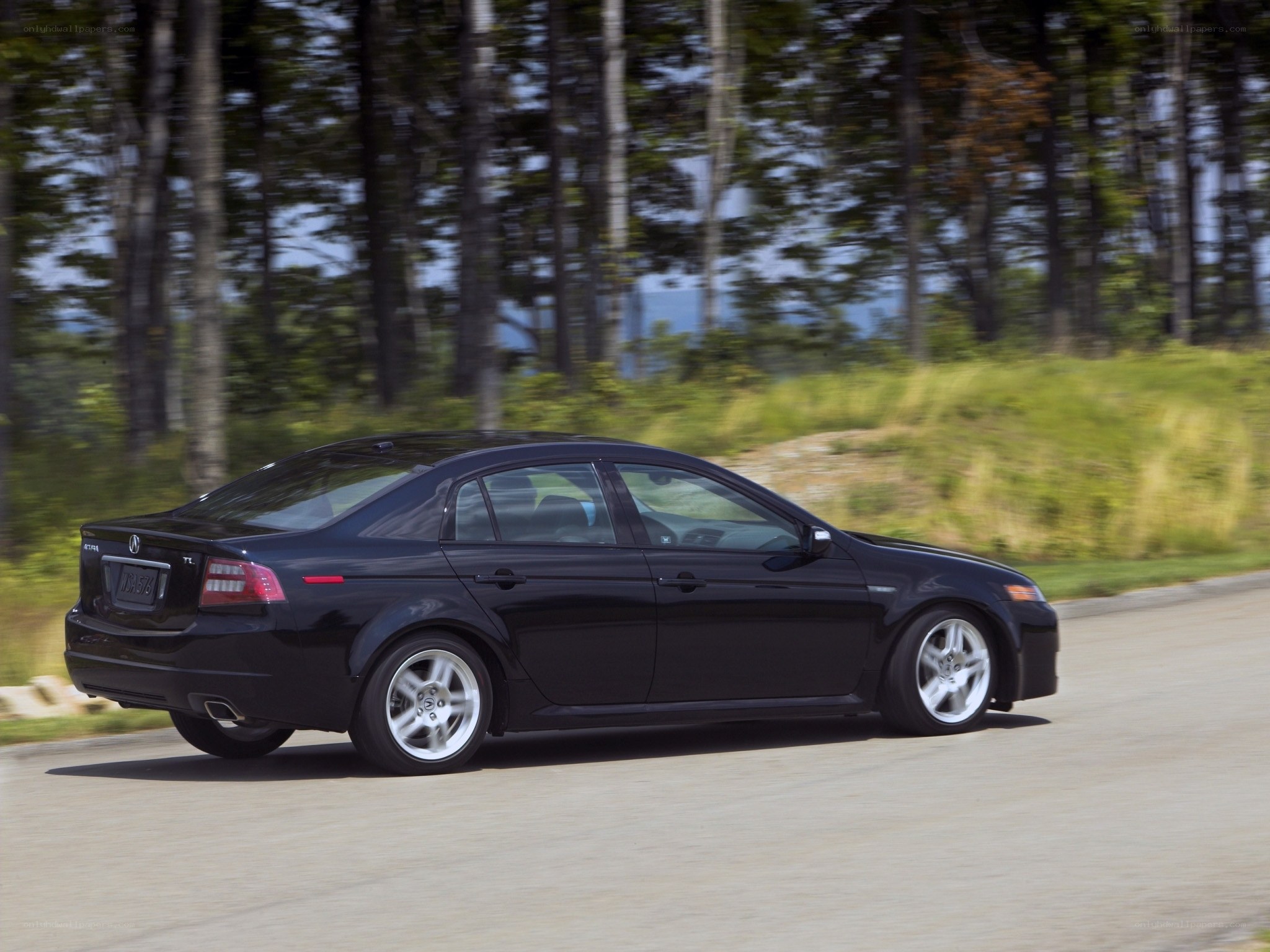 black sedan driving on road