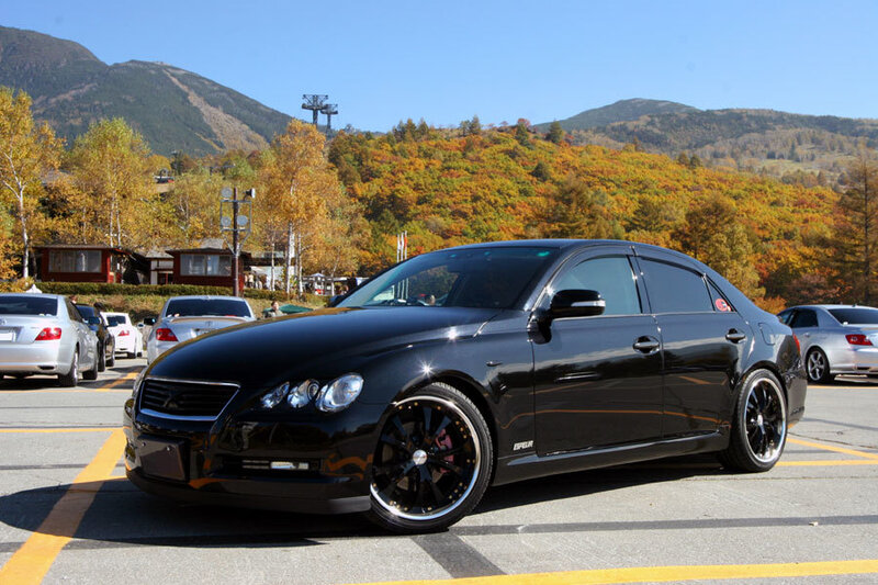 Black sedan in autumn parking lot