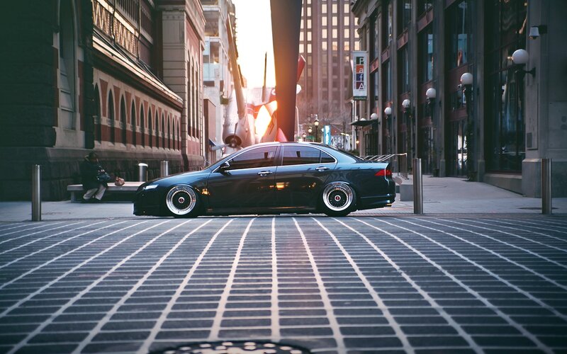 Black sedan in city street