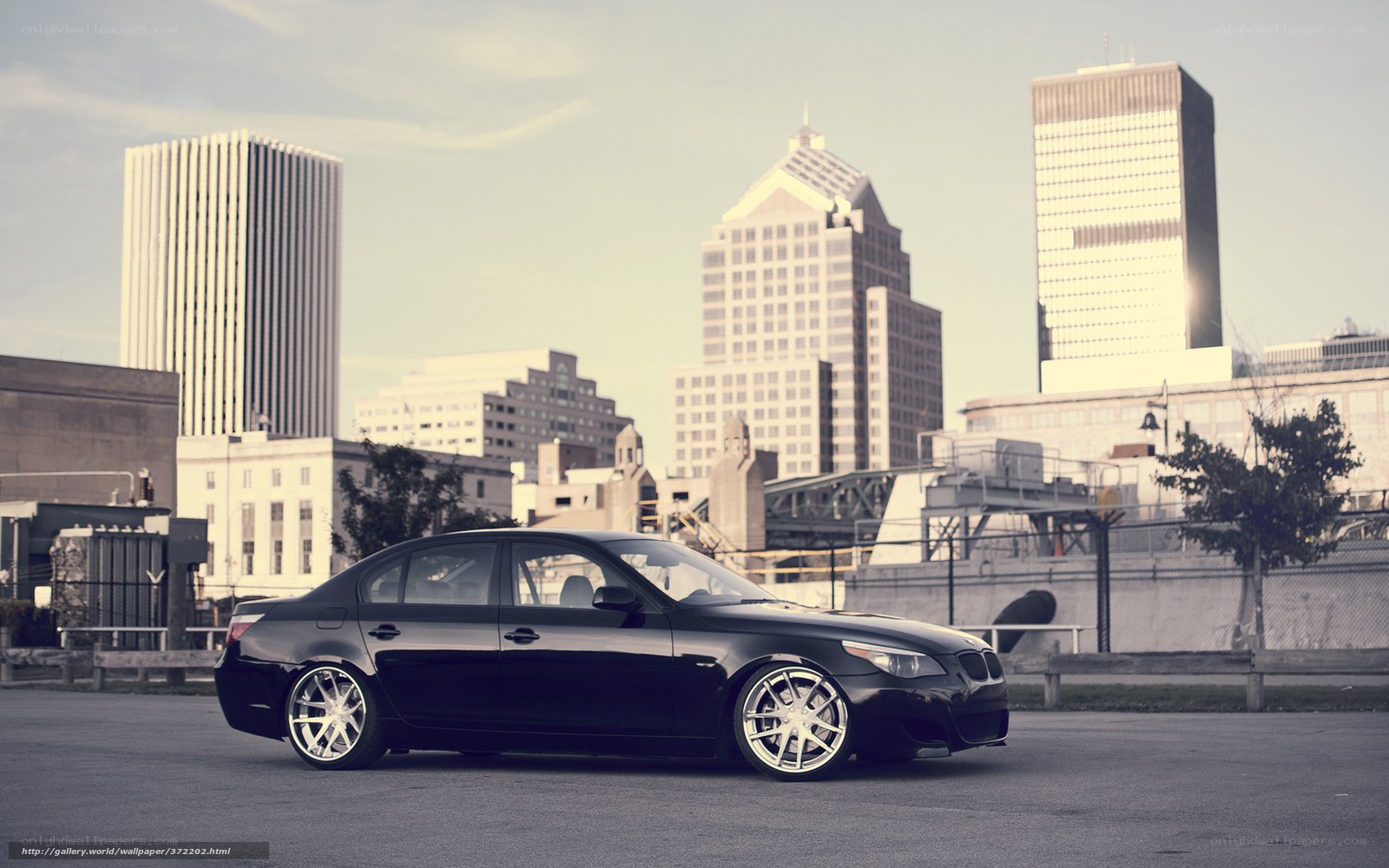 Black sedan in cityscape