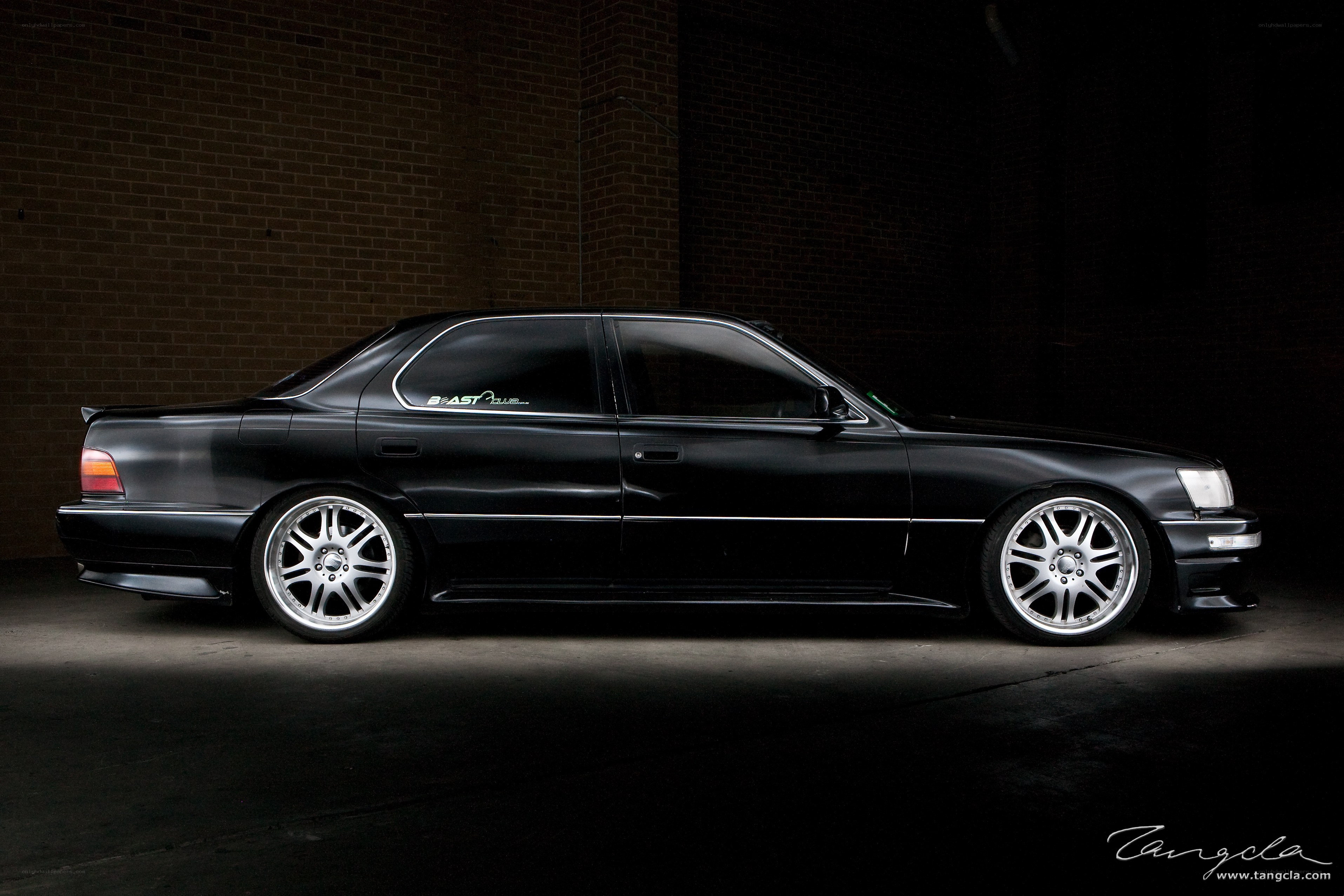 black sedan in dark garage