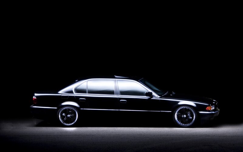 black sedan in dark studio