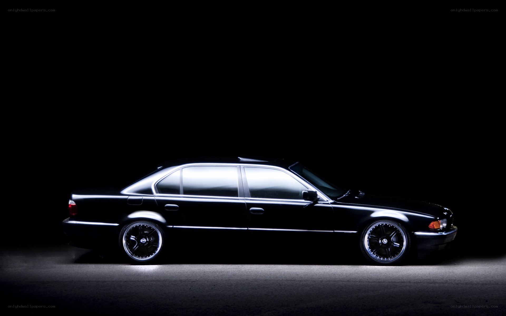 black sedan in dark studio