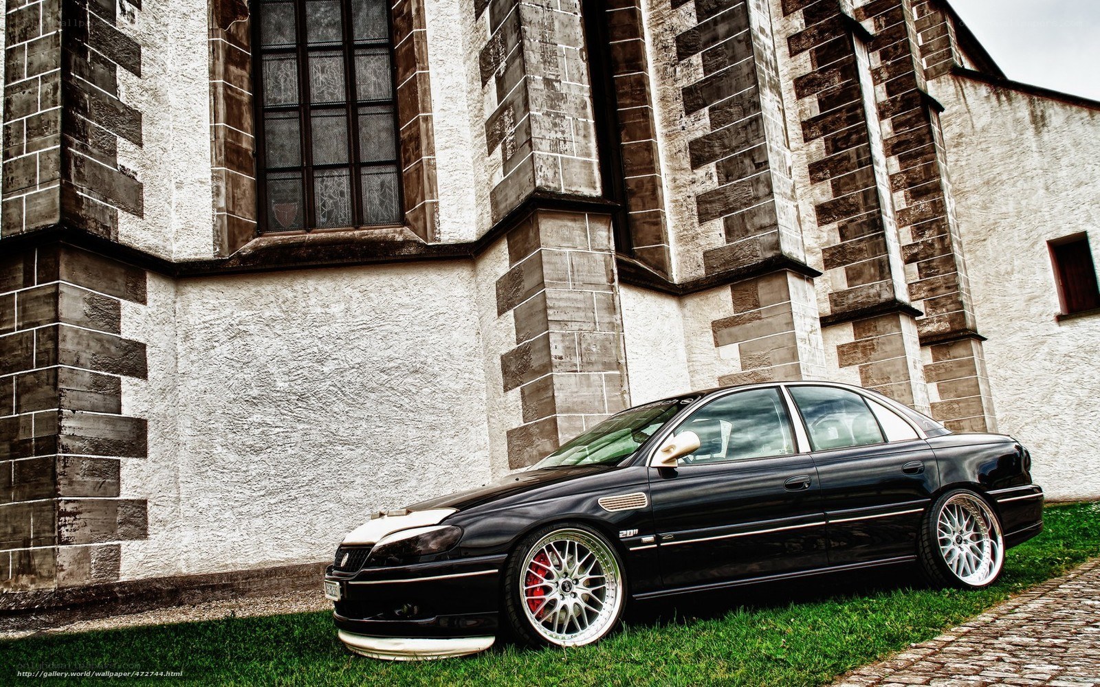 Black sedan in front of church