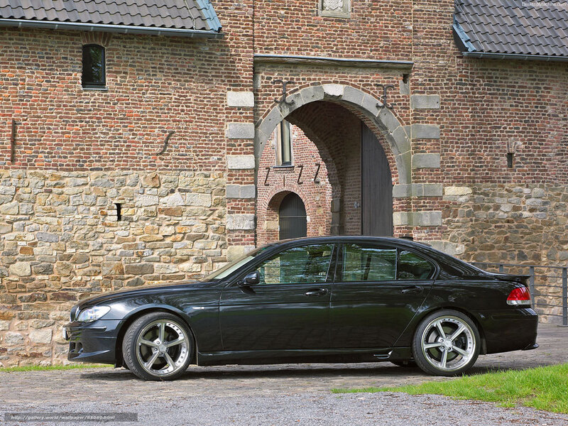 black sedan in front of old building