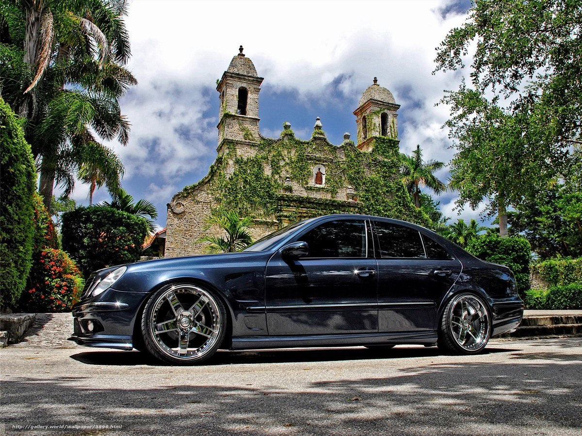 Black sedan in front of old church