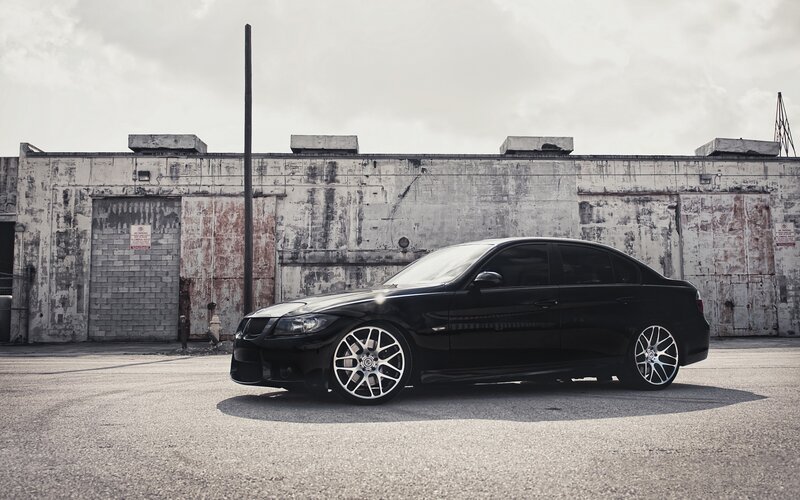 black sedan in industrial lot
