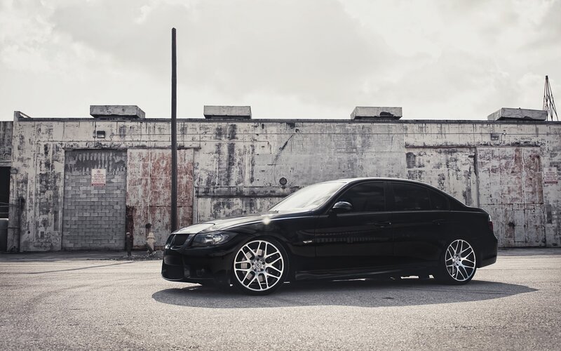 black sedan in industrial lot