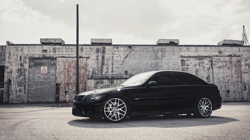 black sedan in industrial lot