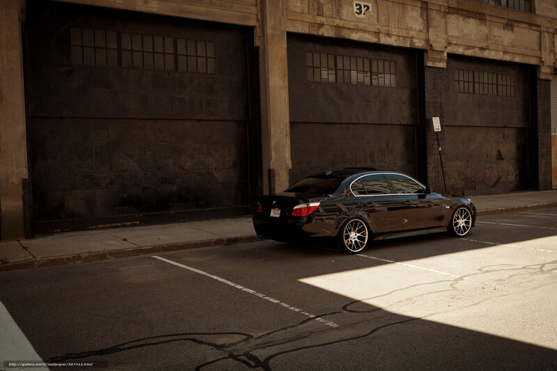 Black sedan in industrial lot
