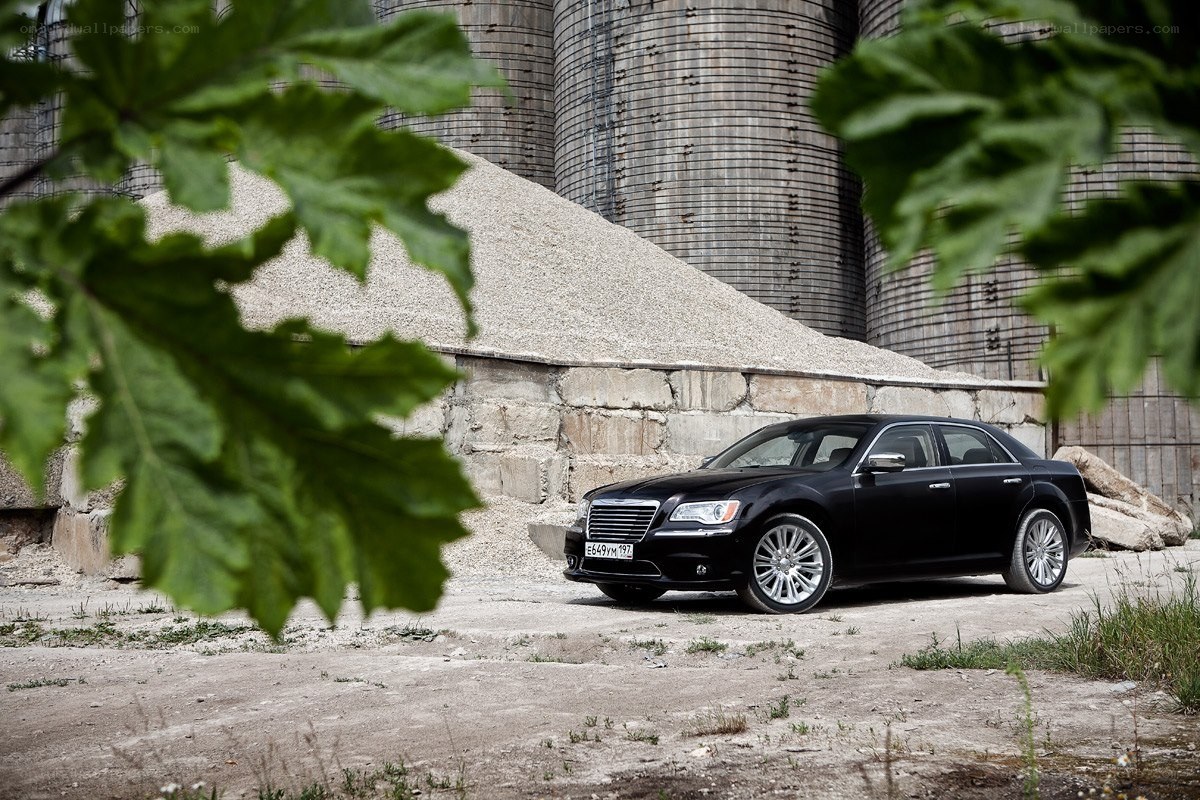 Black sedan in industrial setting