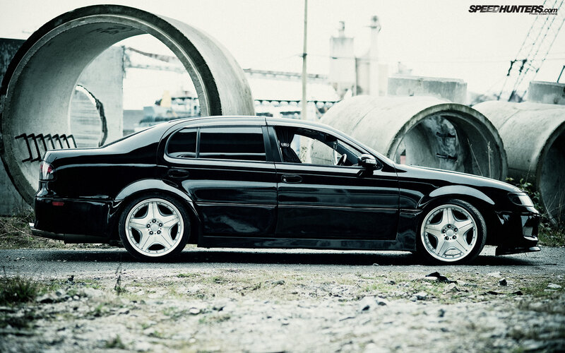 black sedan in industrial setting