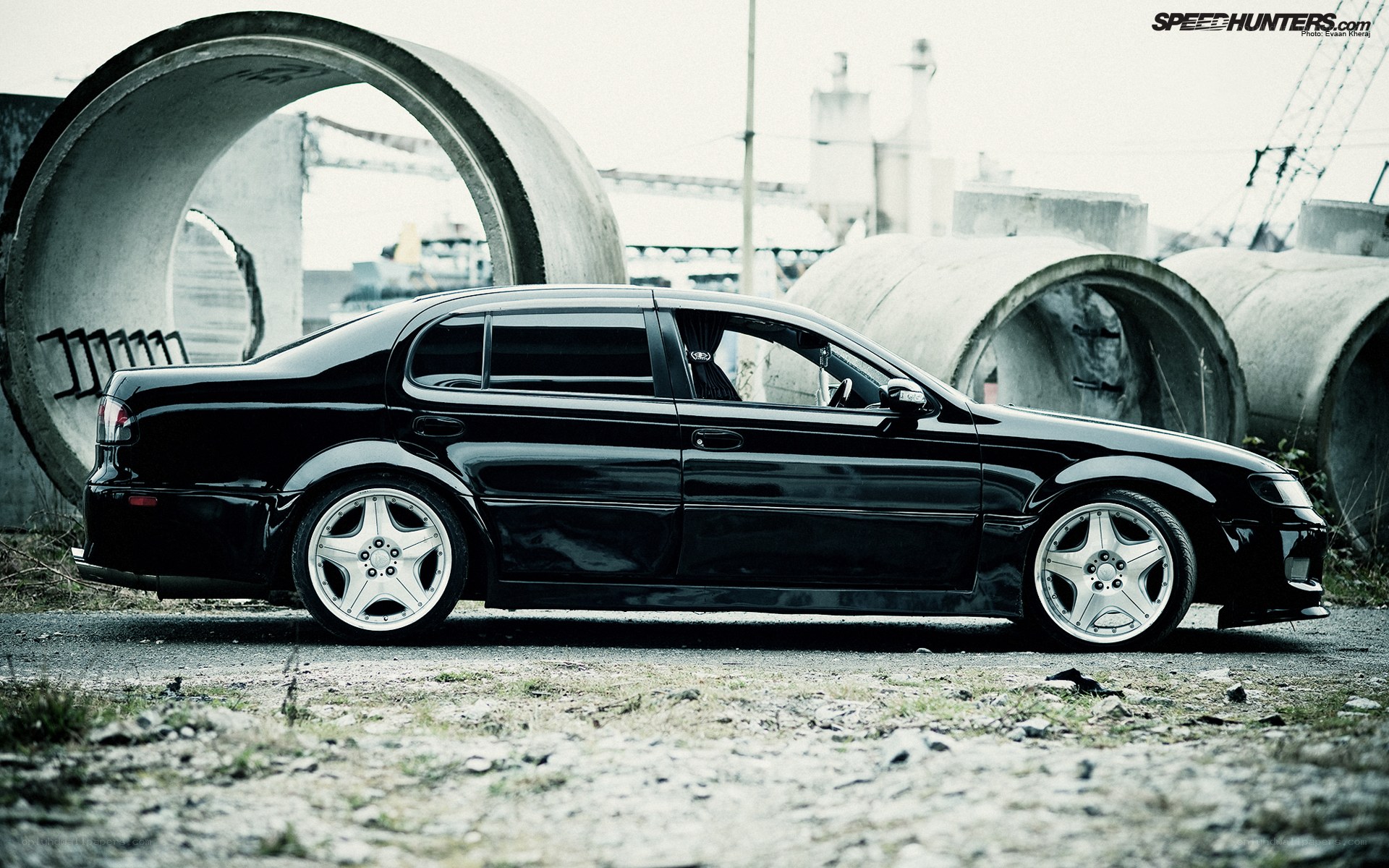 black sedan in industrial setting