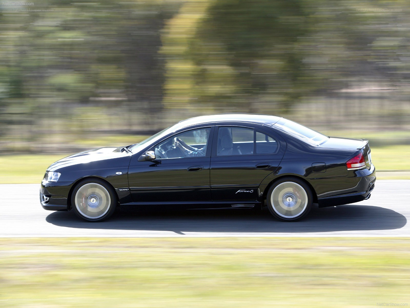black sedan in motion