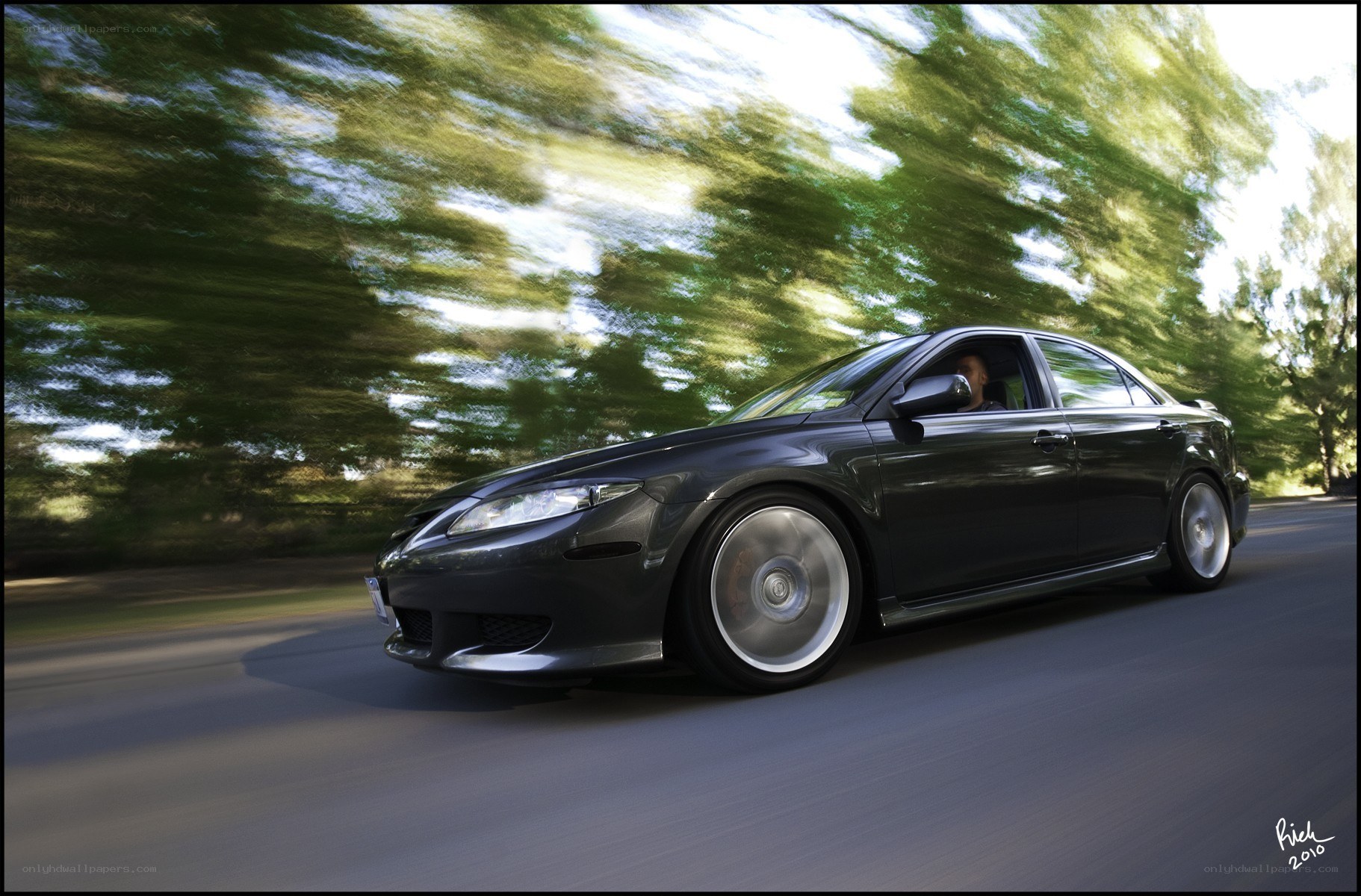 black sedan in motion