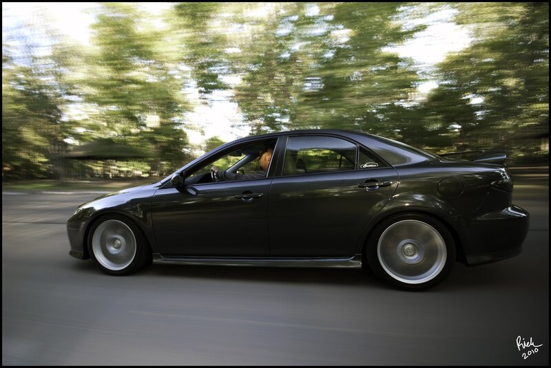 black sedan in motion