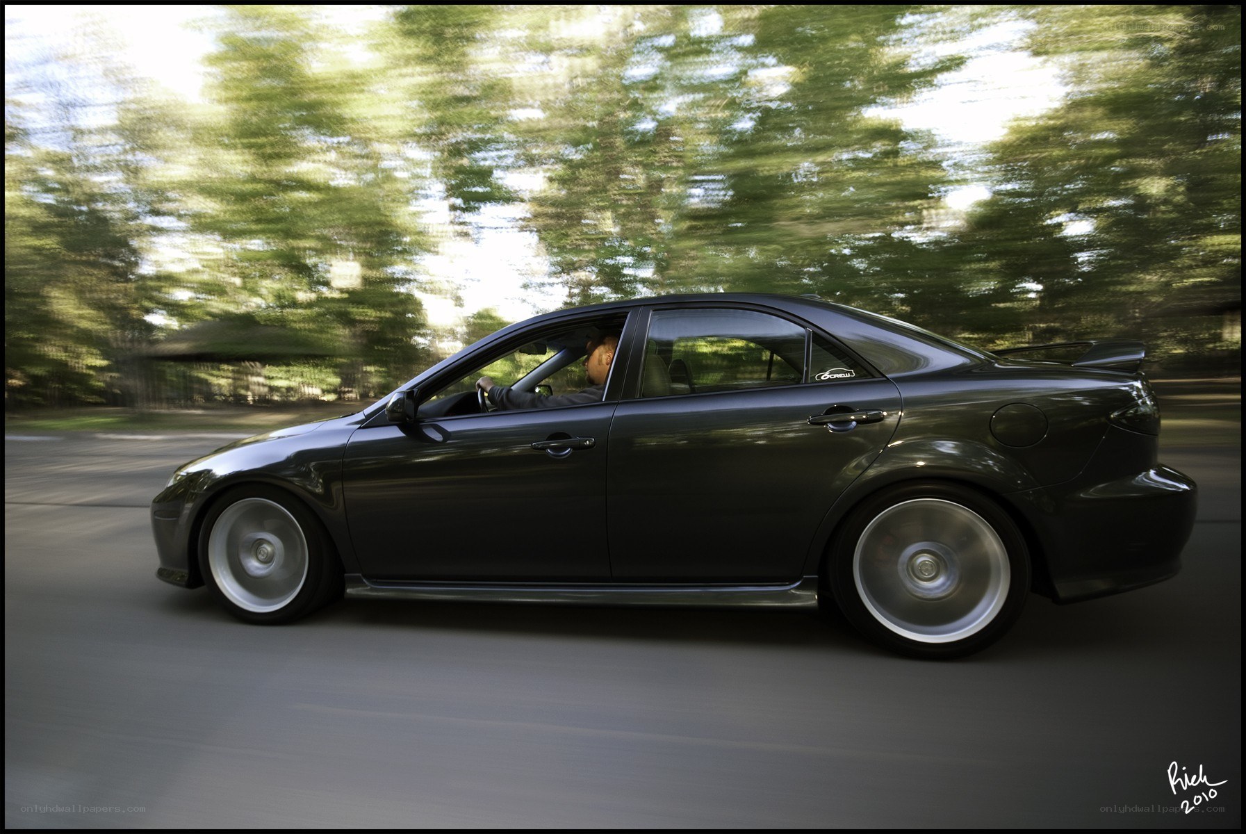 black sedan in motion