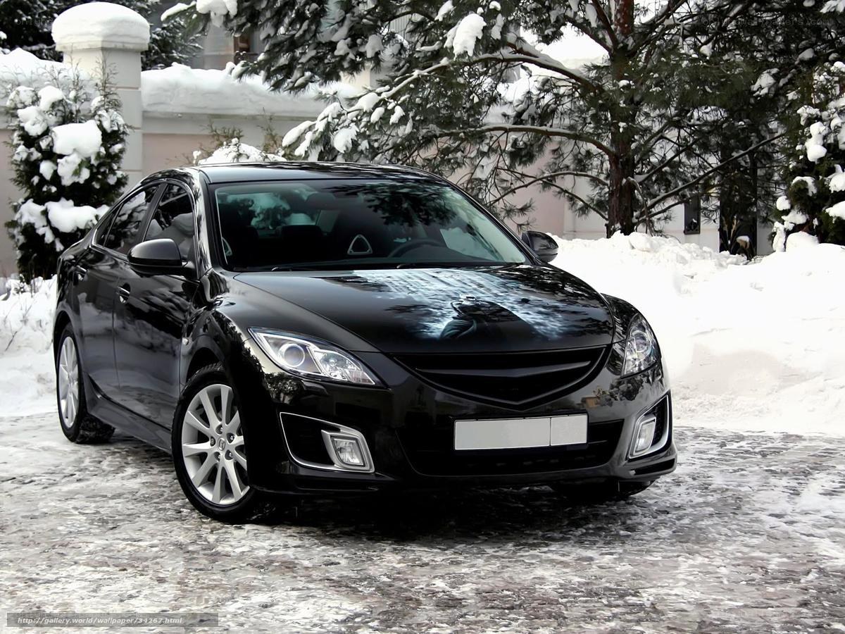 Black sedan in snowy landscape
