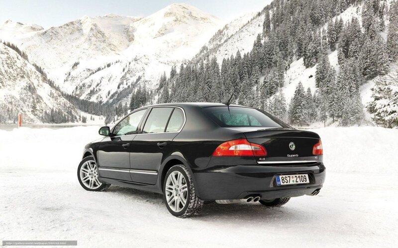 Black sedan in snowy mountains