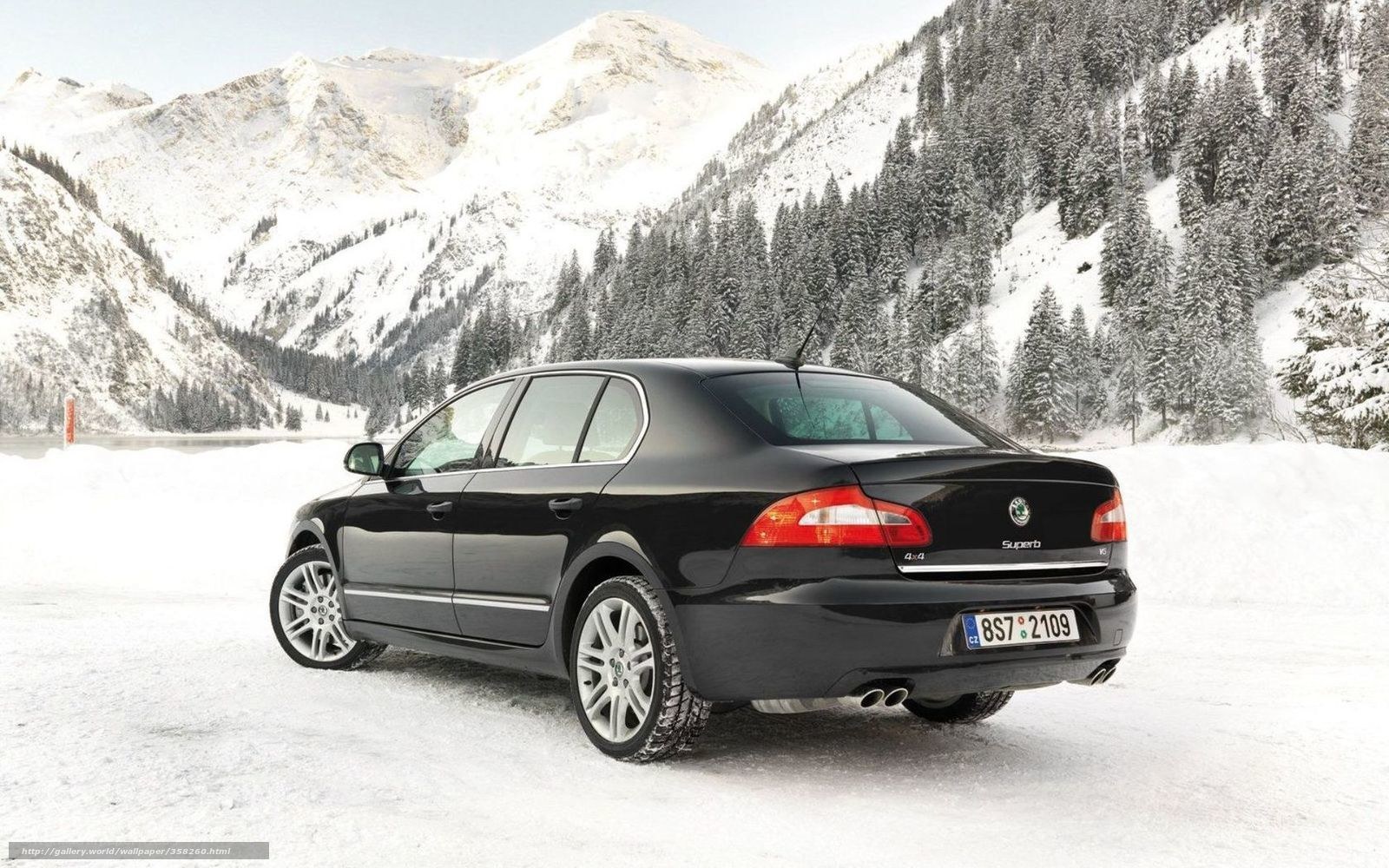 Black sedan in snowy mountains