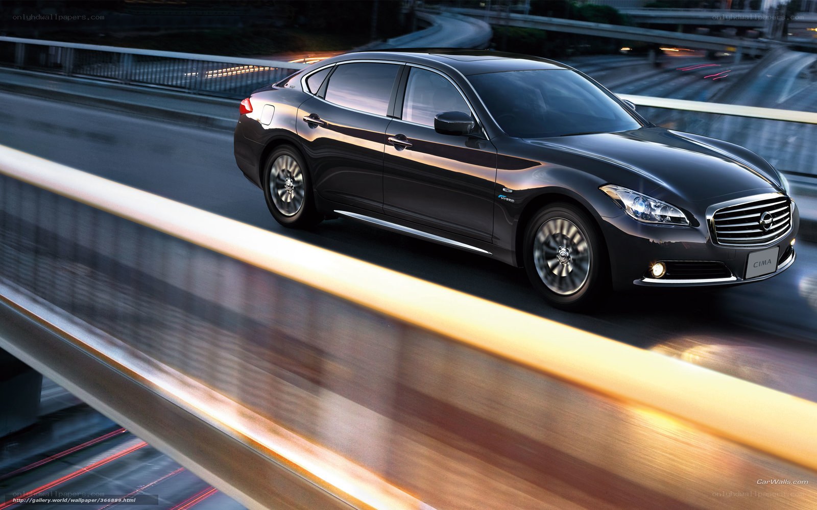 Black sedan on a bridge at night