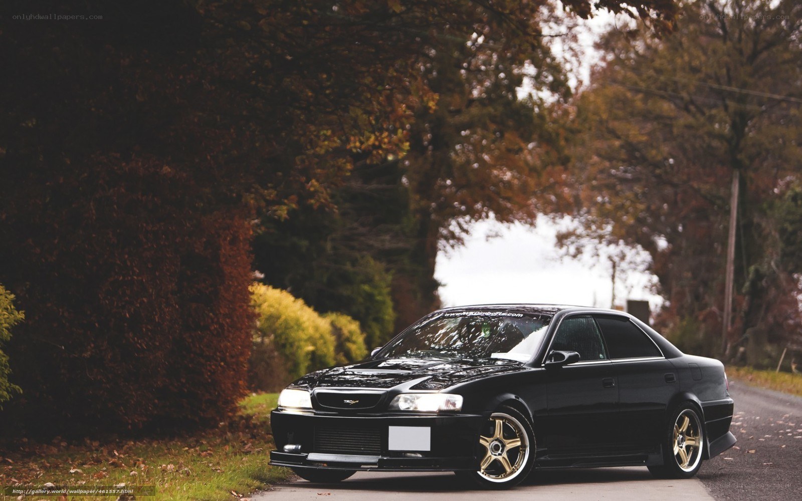 Black sedan on a country road