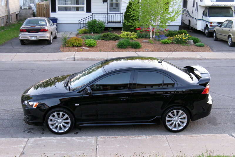 black sedan on a residential street