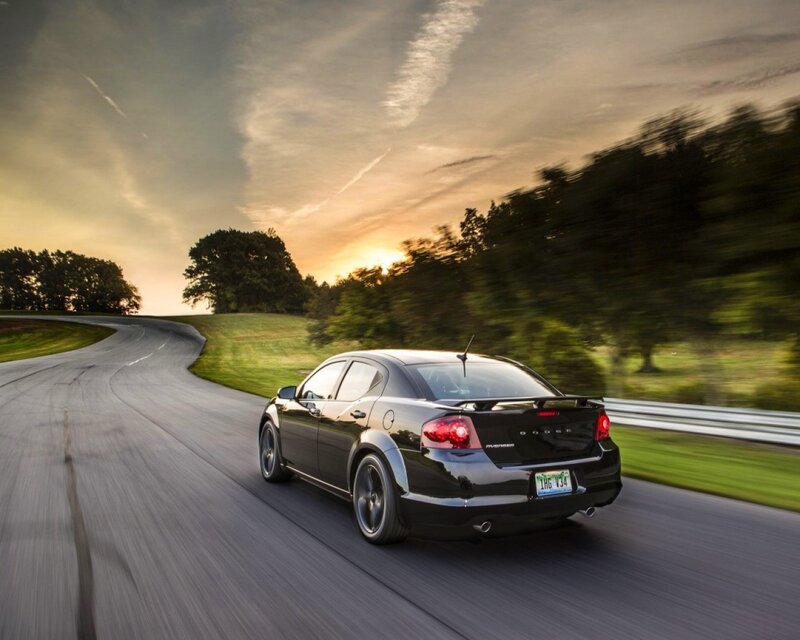 Black sedan on a winding road