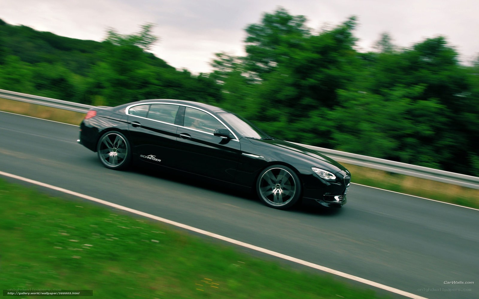 black sedan on a winding road