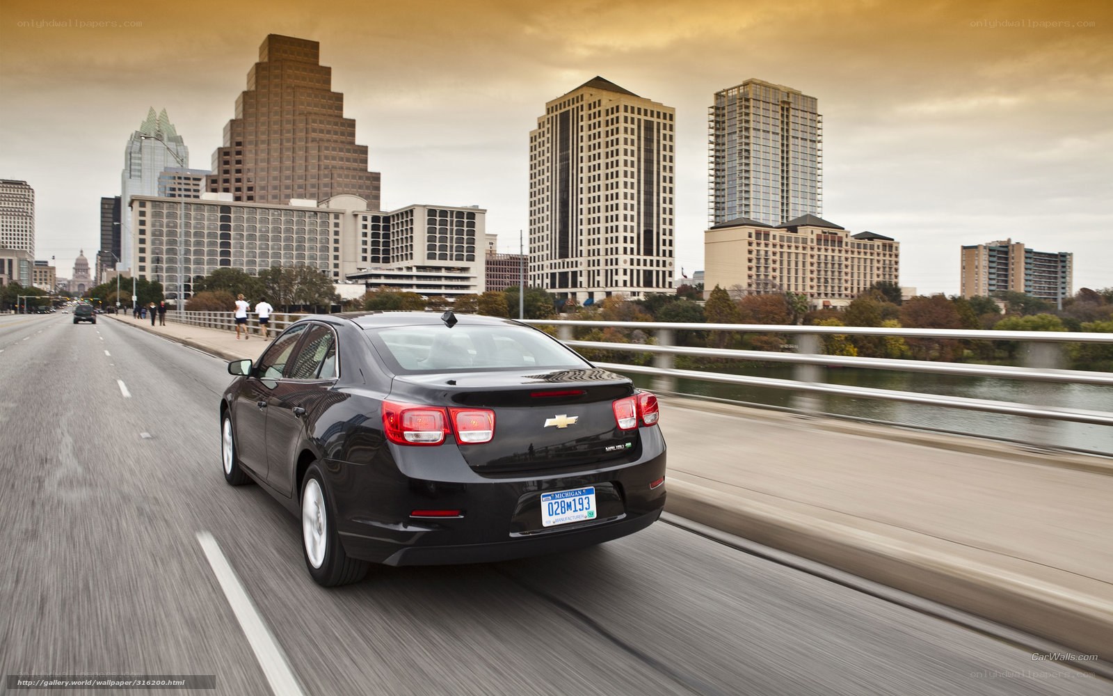Black sedan on city bridge
