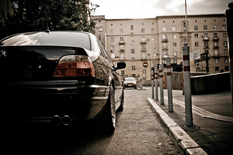 Black sedan on city street