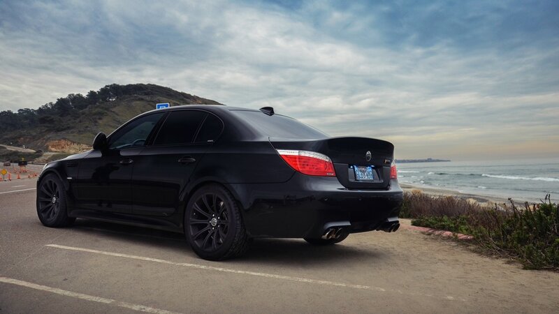 black sedan on coastal road