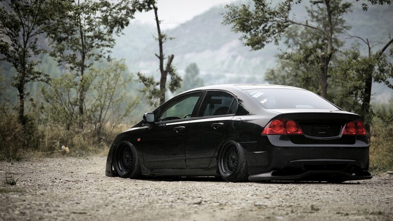 black sedan on gravel road