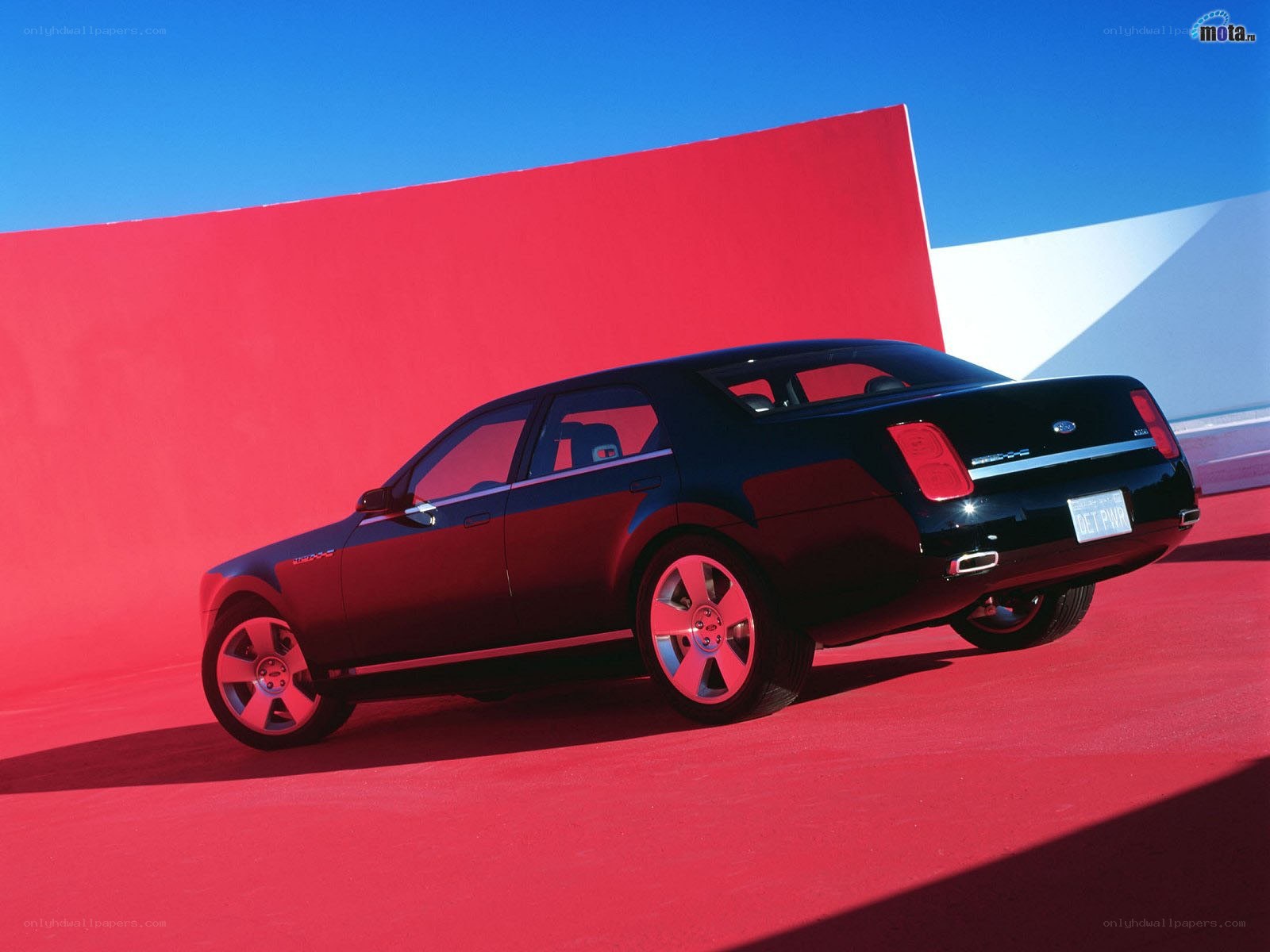 Black sedan on red background