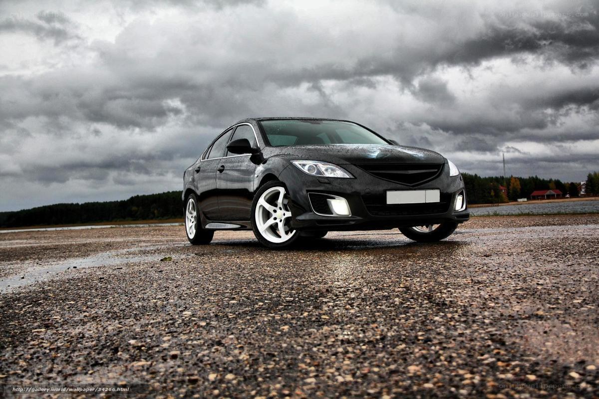 Black sedan on wet pavement