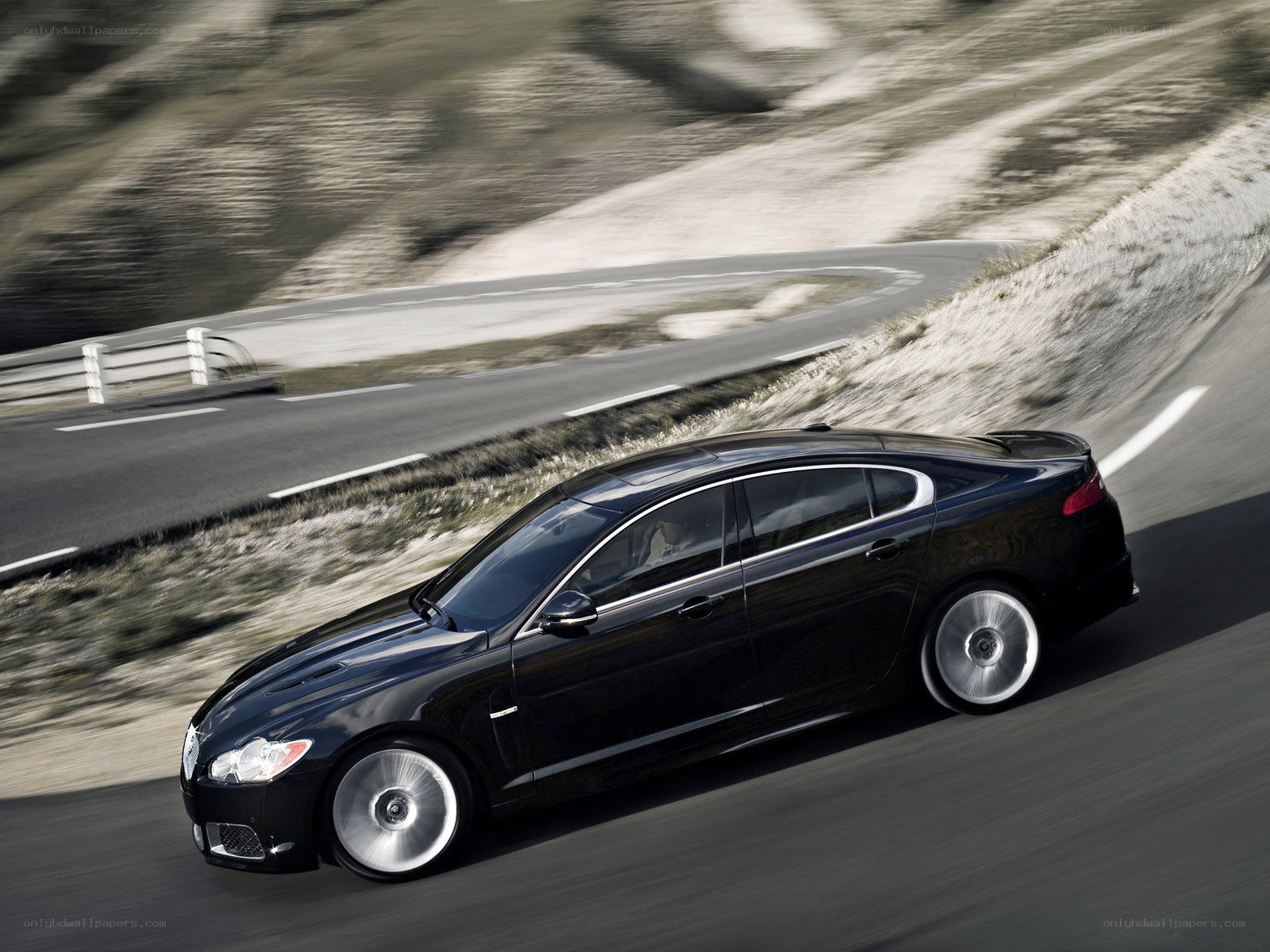 Black sedan on winding road