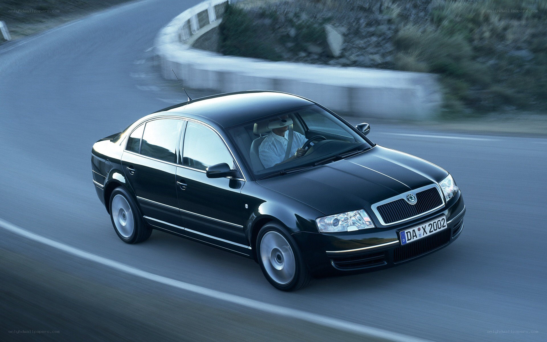 black sedan on winding road