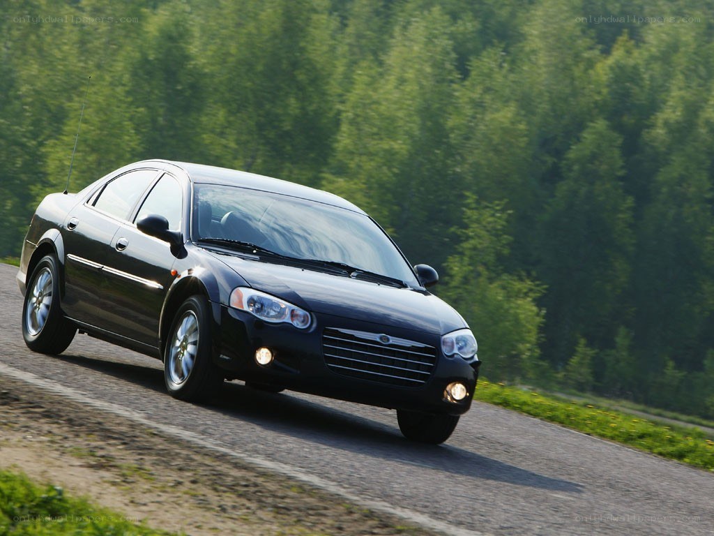 black sedan on winding road