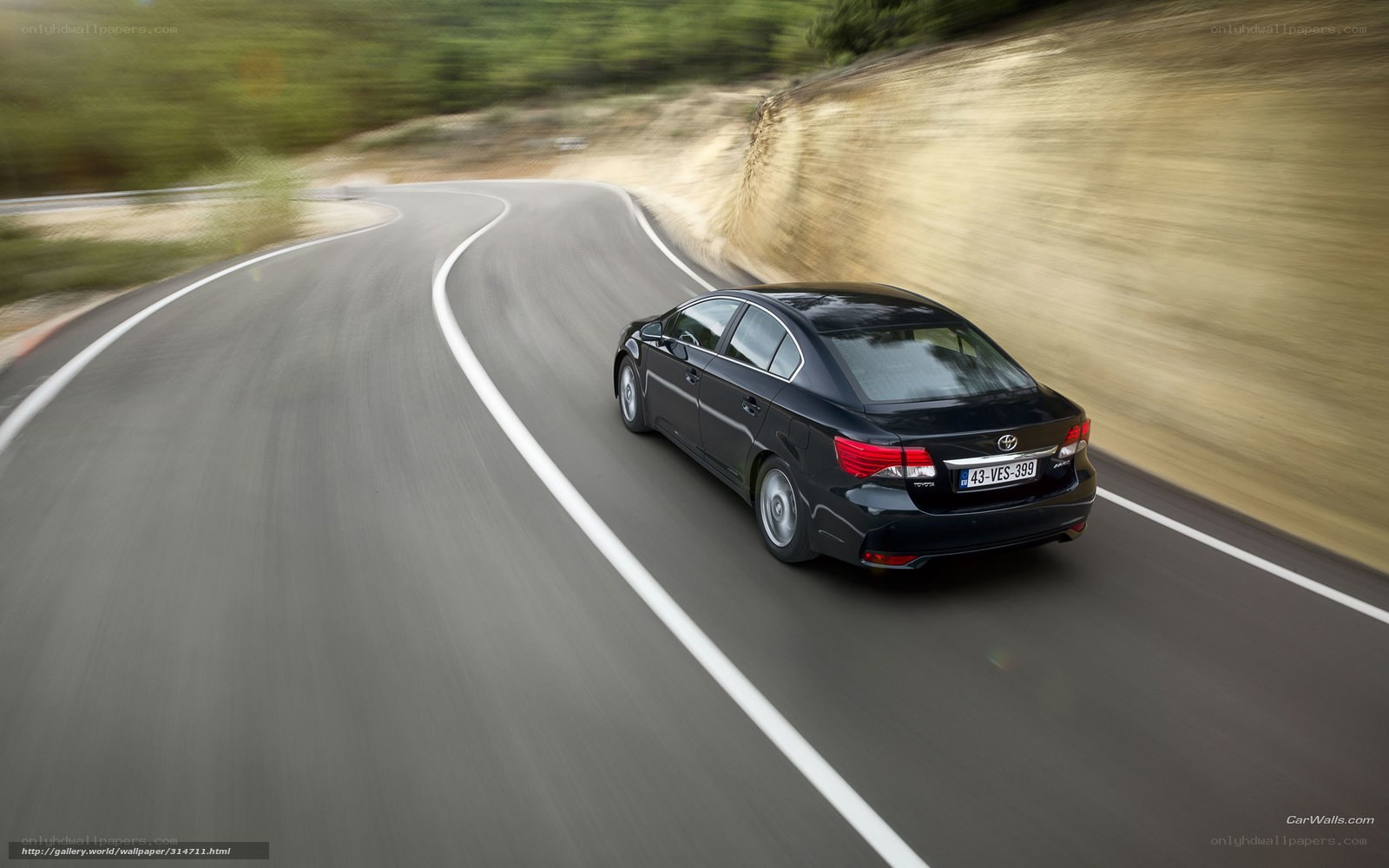 black sedan on winding road