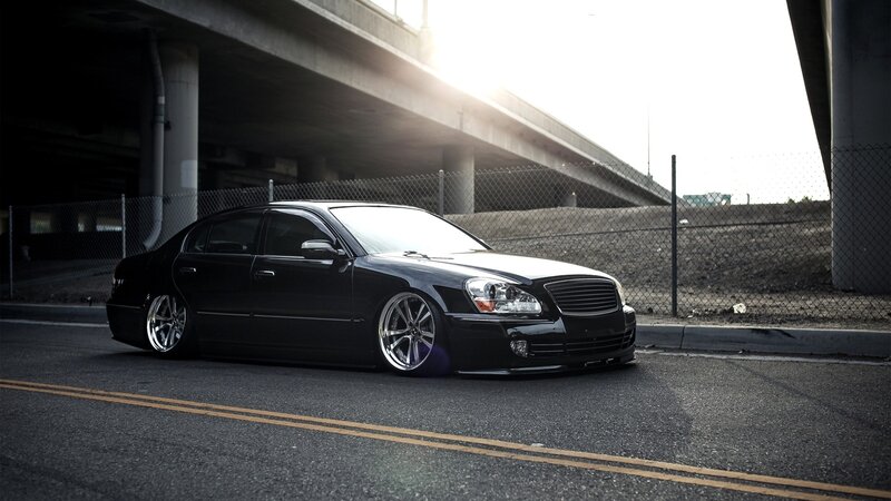 black sedan under overpass