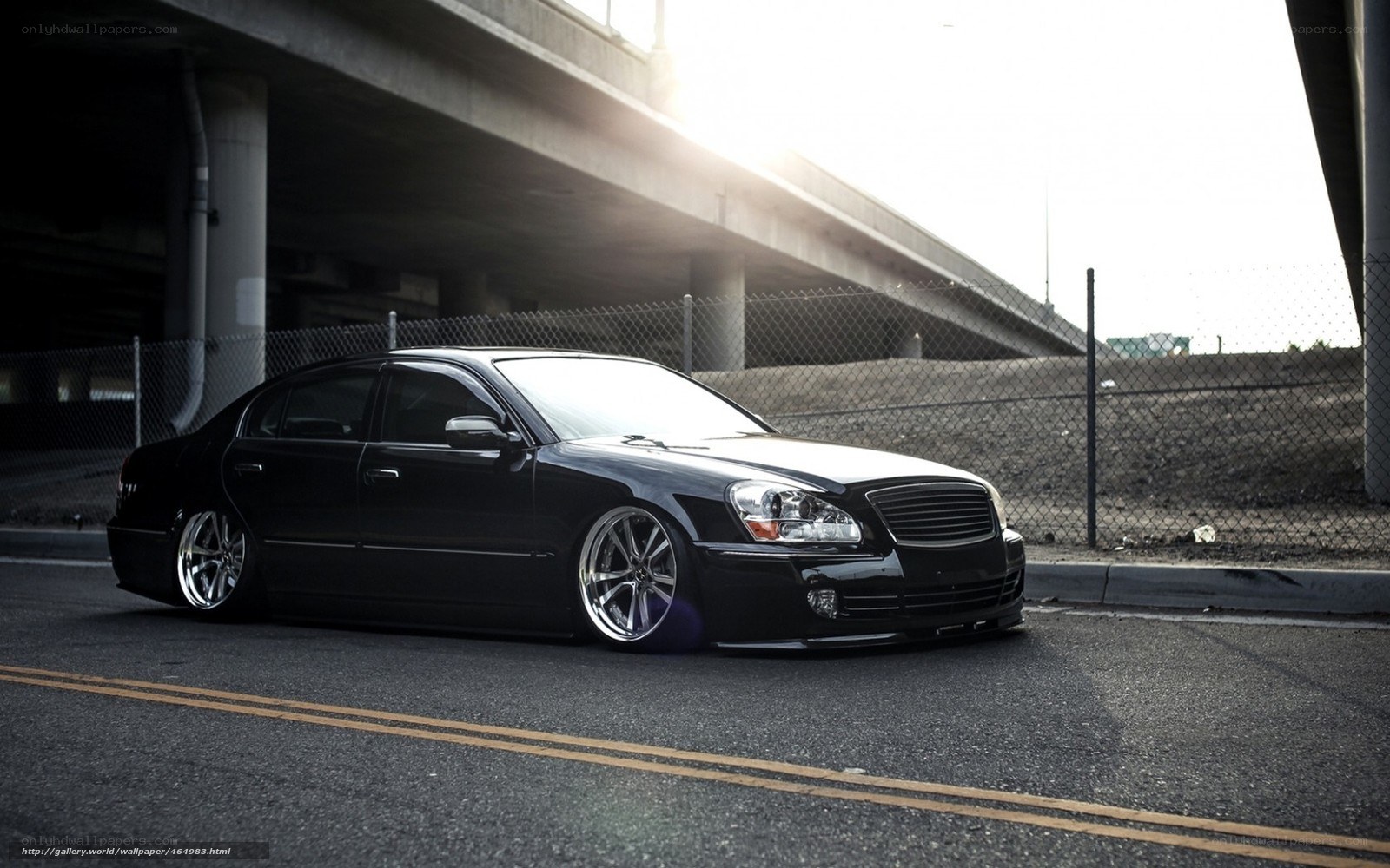 black sedan under overpass