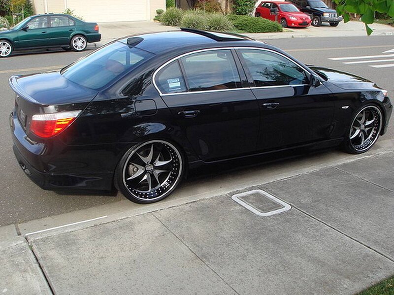 black sedan with custom wheels