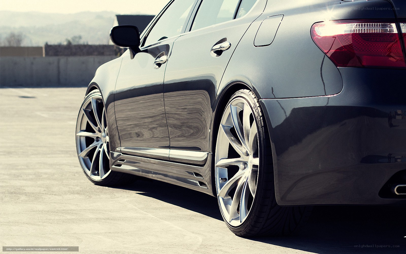 black sedan with custom wheels