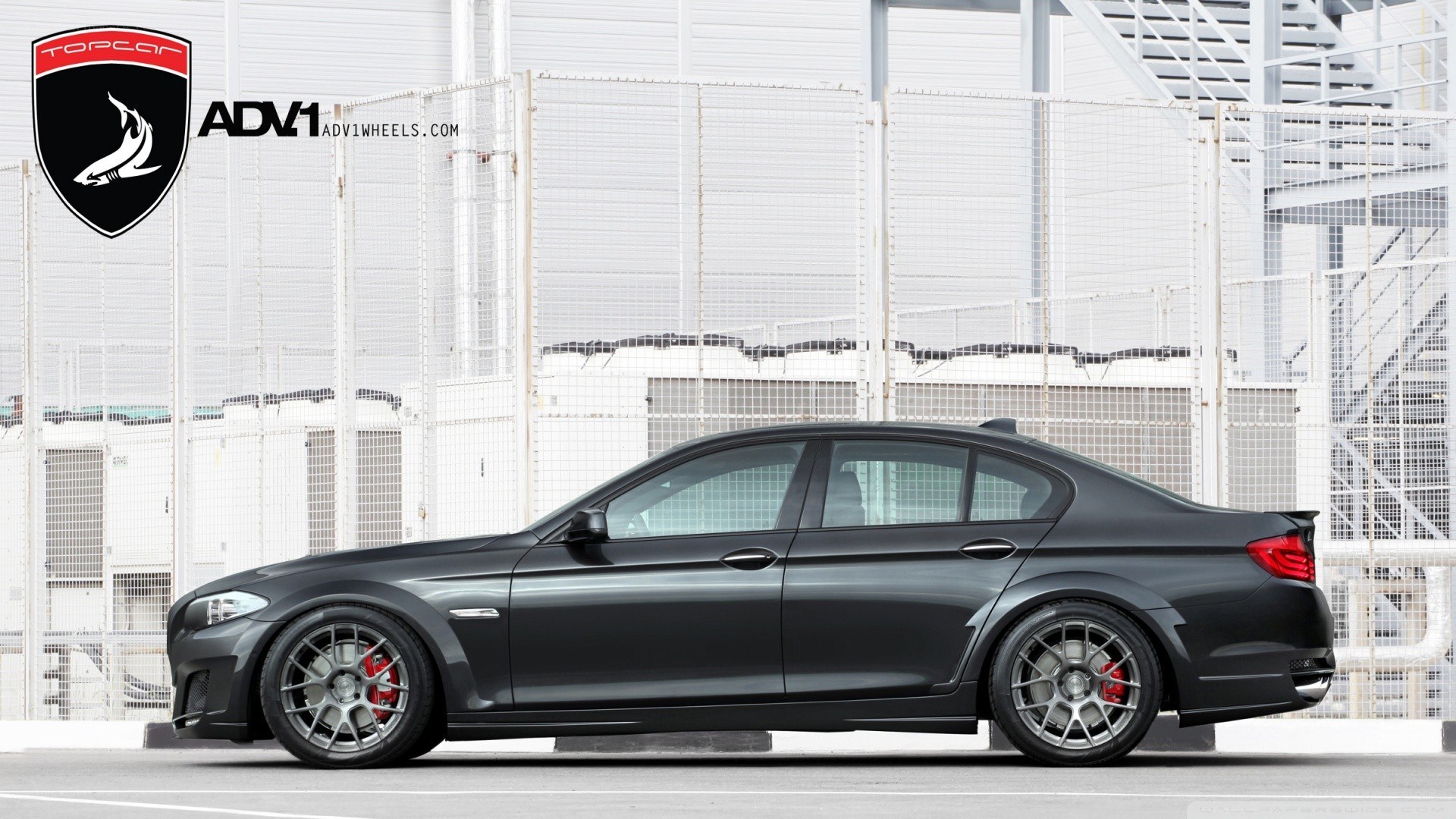 black sedan with custom wheels