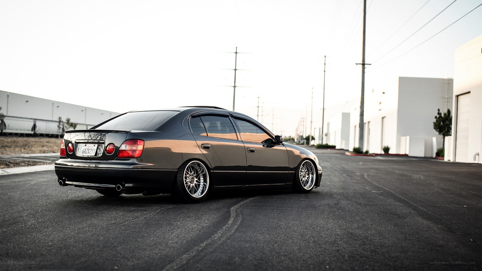 black sedan with custom wheels
