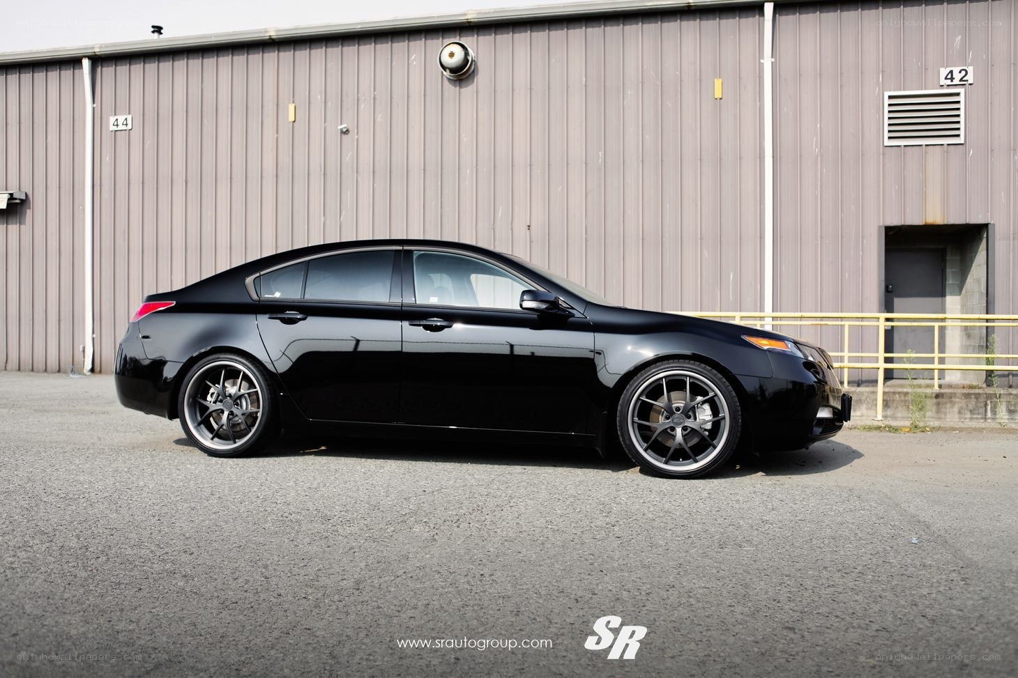 black sedan with custom wheels
