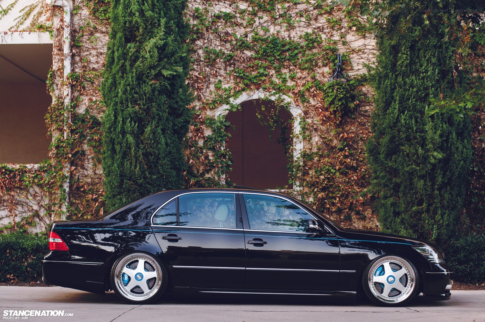 black sedan with custom wheels